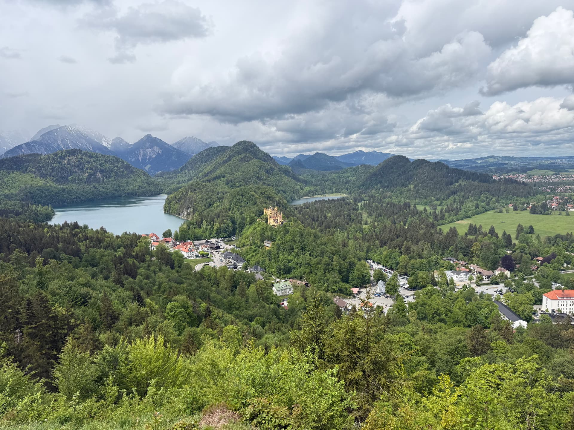 Forest viewpoint beyond Marienbrücke with Neuschwanstein, Hohenschwangau, and Alpsee