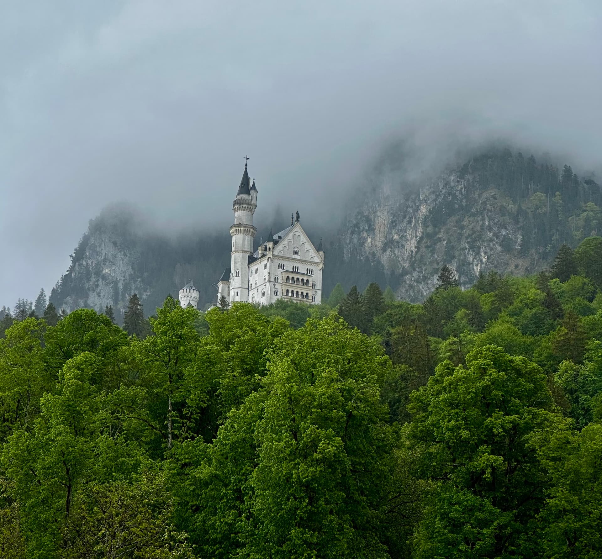 First view of Neuschwanstein Castle from the valley path near Hohenschwangau