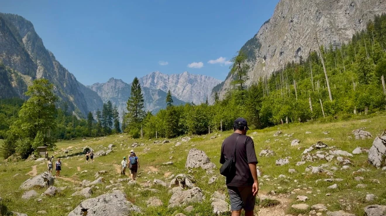 Open meadow towards Röthbachfall with mountain walls at the end of the valley