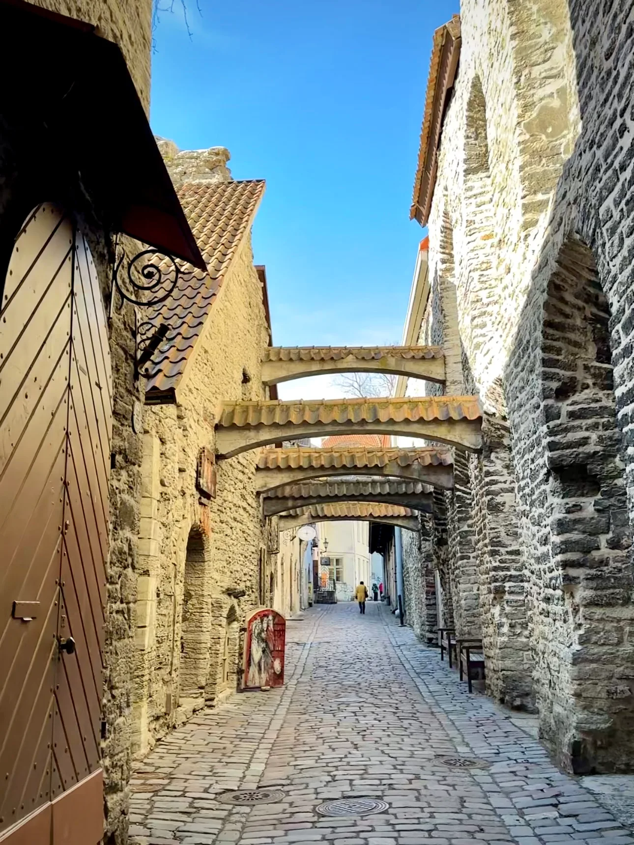 Stone arches and artisan workshop doors in St Catherine's Passage, Tallinn Old Town